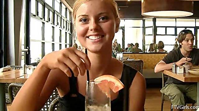 Jessi is drinking cocktail in a cafe showing her sexy legs