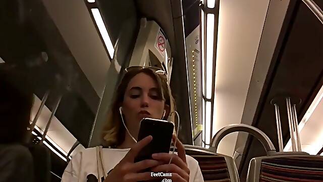 Stunning babe with gorgeous feet captured in the train by a horny voyeur