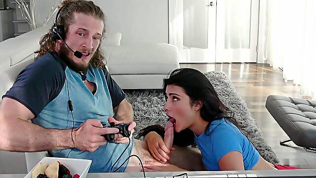 Adria Rae is sucking Brick Danger's cock as he playing video games