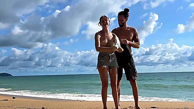 Tattooed hottie and her partner are naked on the beach