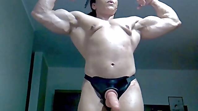 Muscular female athlete flexes her muscles in a vertical POV