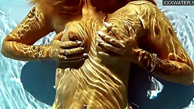 French model sucks cock while submerged in pool