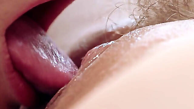 Blondes tongue flicked against the excited clit of a hairy pussy