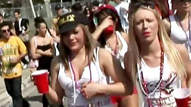Nasty girls demonstrate their tits at a carnival in reality scene