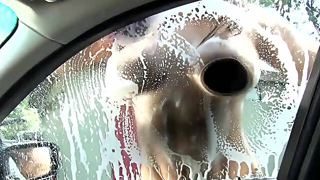 Sexy and wet girl washing car gives a good boobjob