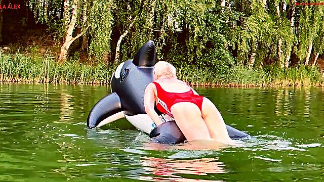 A fun game on the lake with a big, squeaky, naughty inflatable whale